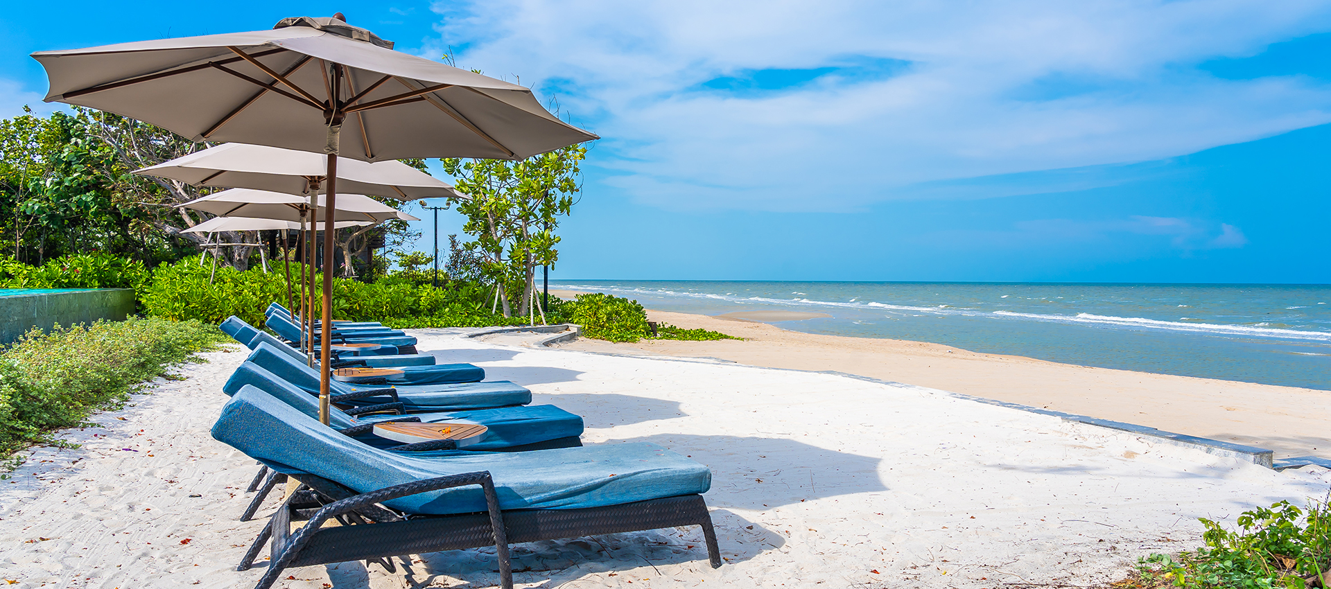 Umbrella and chair on the beach sea ocean with blue sky and white cloud